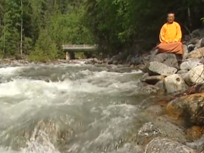 Zasep Tulku Rinpoche meditates by river Nelson BC