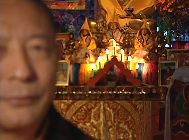 Zasep Rinpoche in an earlier picture in front of an altar with offerings. Enlightened deities, Buddhas and Bodhisattvas, play a central role in Tibetan Buddhist practice. Meditating on a deity who embodies Perfection is helpful. 