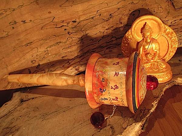 Students wearing uniforms in front of a prayer wheel in Hunder