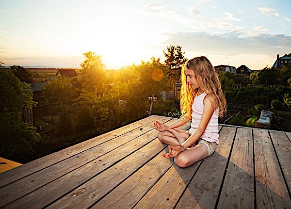 Buddha Weekly Child meditating at sunrise Buddhism