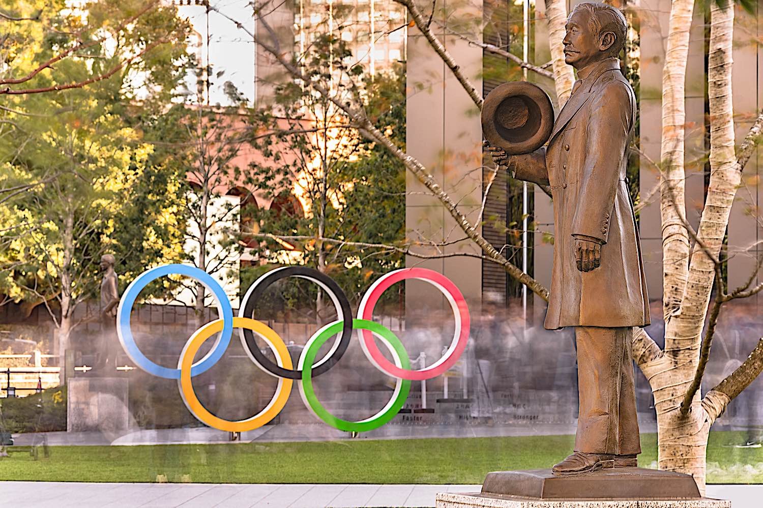 Buddha Weekly A statue of Judo sport founder Kano Jigoro in front of the Olympic Rings monument in Japan dreamstime l 175142826 Buddhism