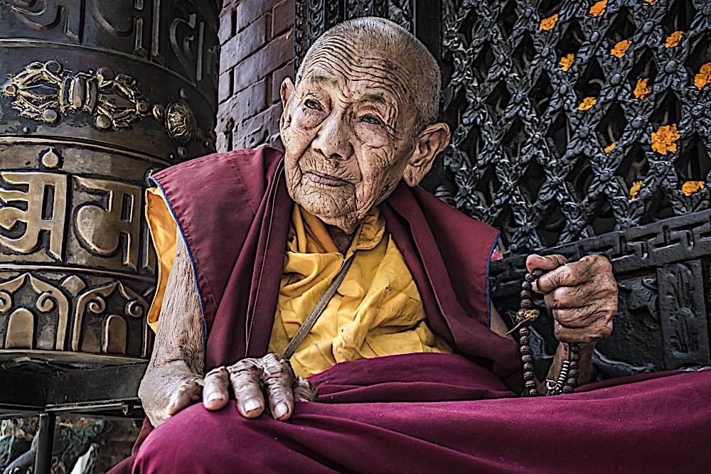 Buddha Weekly Bodnath Katmandu Nepal Sep 9 2017 Portait of Nepalese Buddhist nun praying in front of Bodnath stupa dreamstime xl 180424371 Buddhism