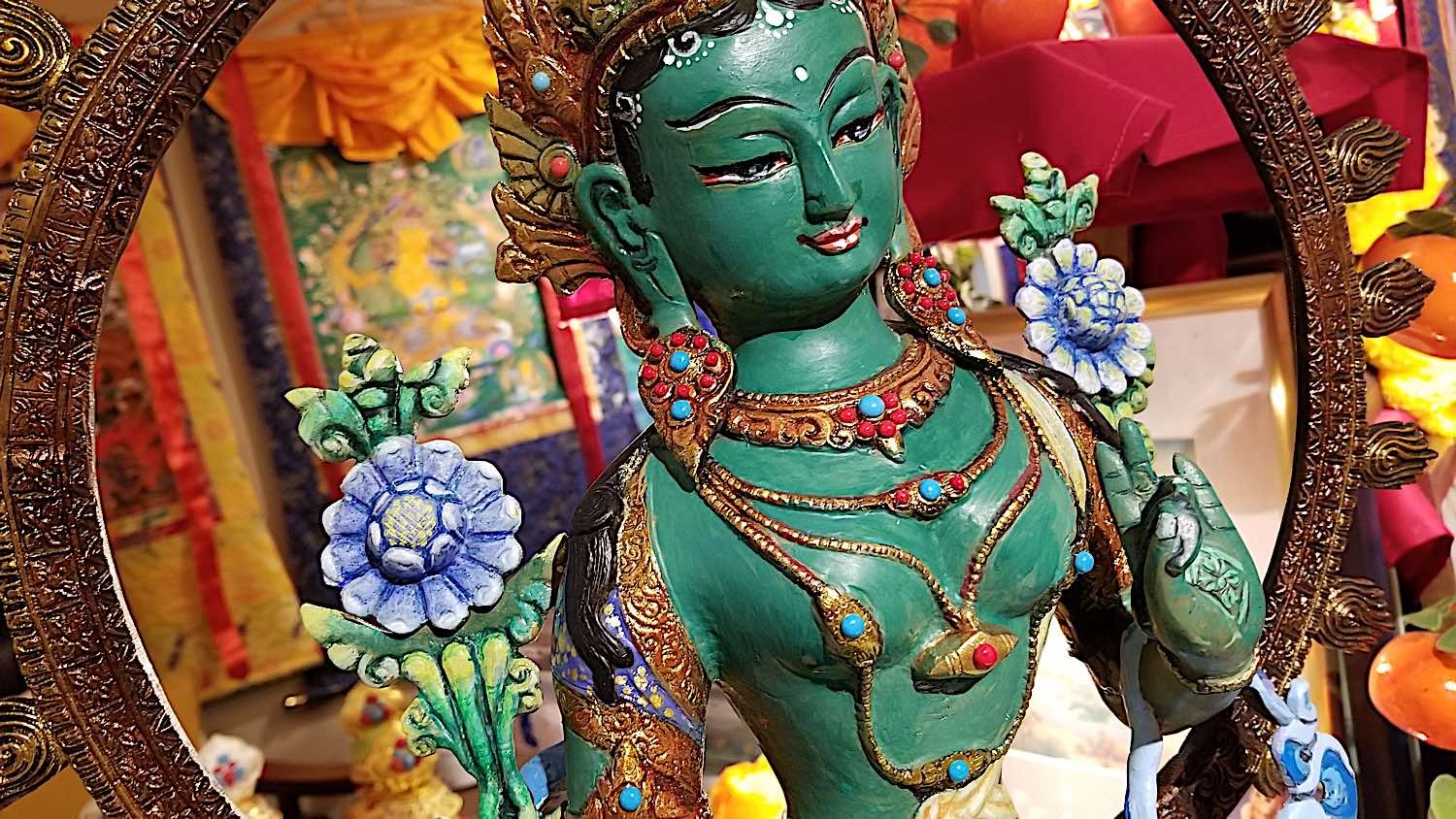 A beautiful devotional practice is to pain your own statues. This beautiful "thanka painted" statue of Chittamani Tara started out as an unpainted bronze. Buddha Weekly's volunteer art director Kam Yu, as a devotional practice to Tara, beautifully painted and decorated a Chittamni Tara statue after filling with mantras and blessings. This is one of the most beautiful practices of devotion. He painted the flowers blue, and jewelry in gold foil. The body is matte varnished while the silk clothing with elaborate designs painted on, are glossy. As a final touch he added Turquoise and coral gems.