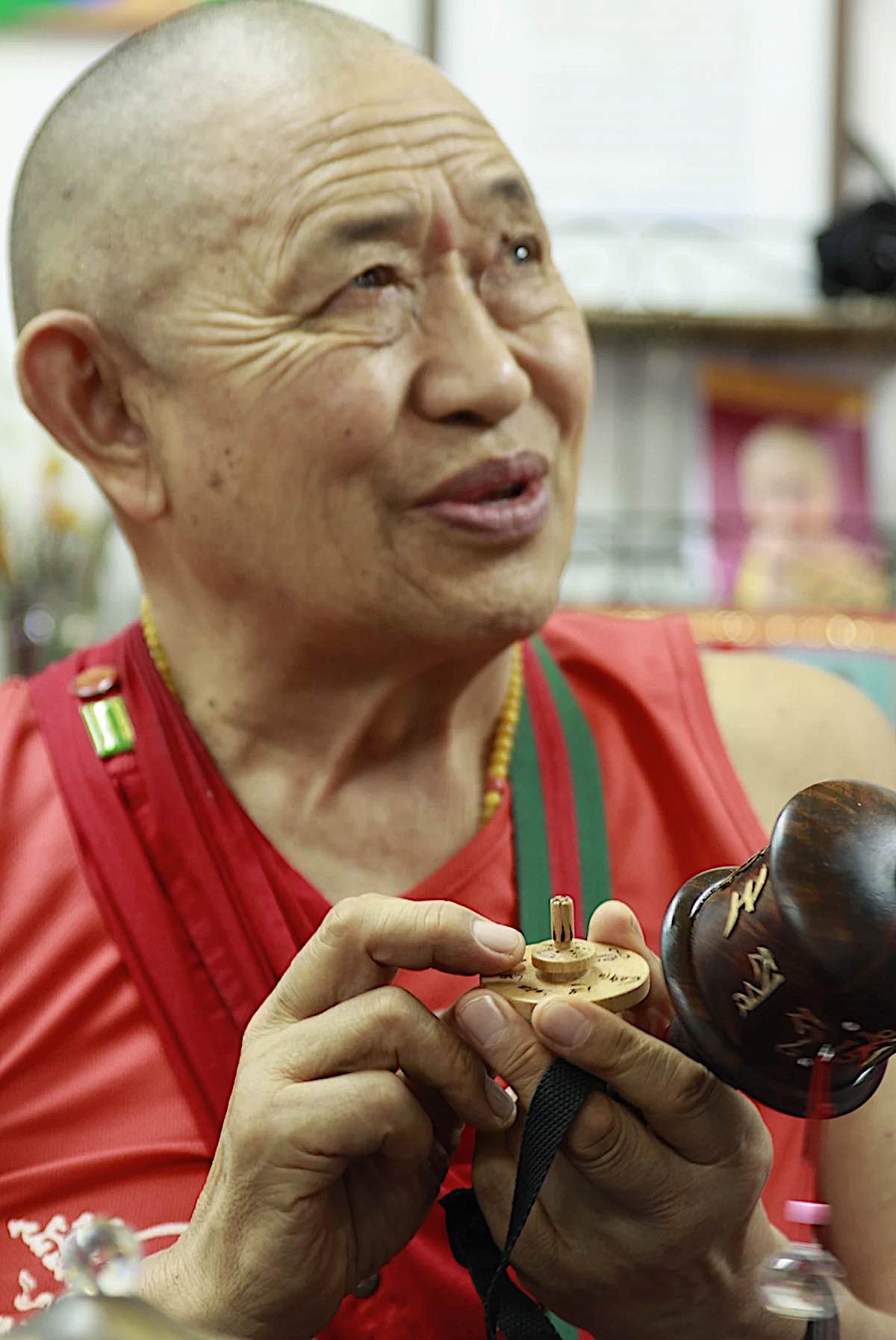 Buddha Weekly H.E. Garchen Rinpoche at the workshop of Holy Land Prayer Wheels in Israel with a prayer wheel top for children Buddhism