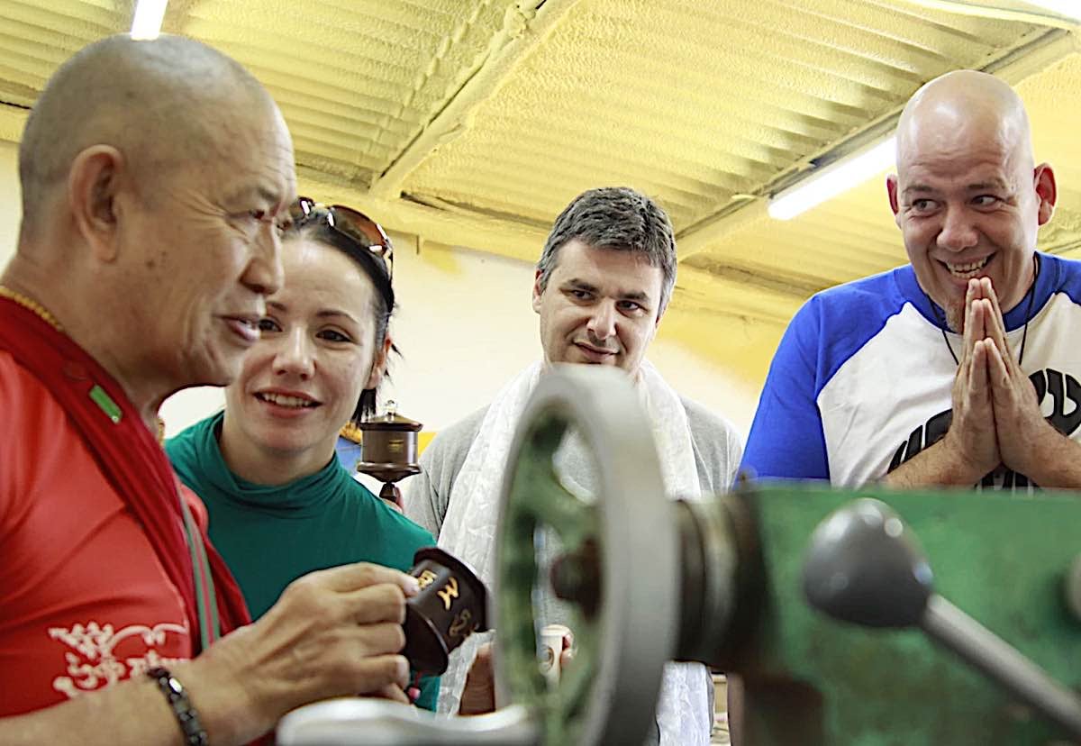 Buddha Weekly H.E. Garchen Rinpoche with Micha and Strauss at the workshop of Holy Land Prayer Wheels in Israel with lathe Buddhism