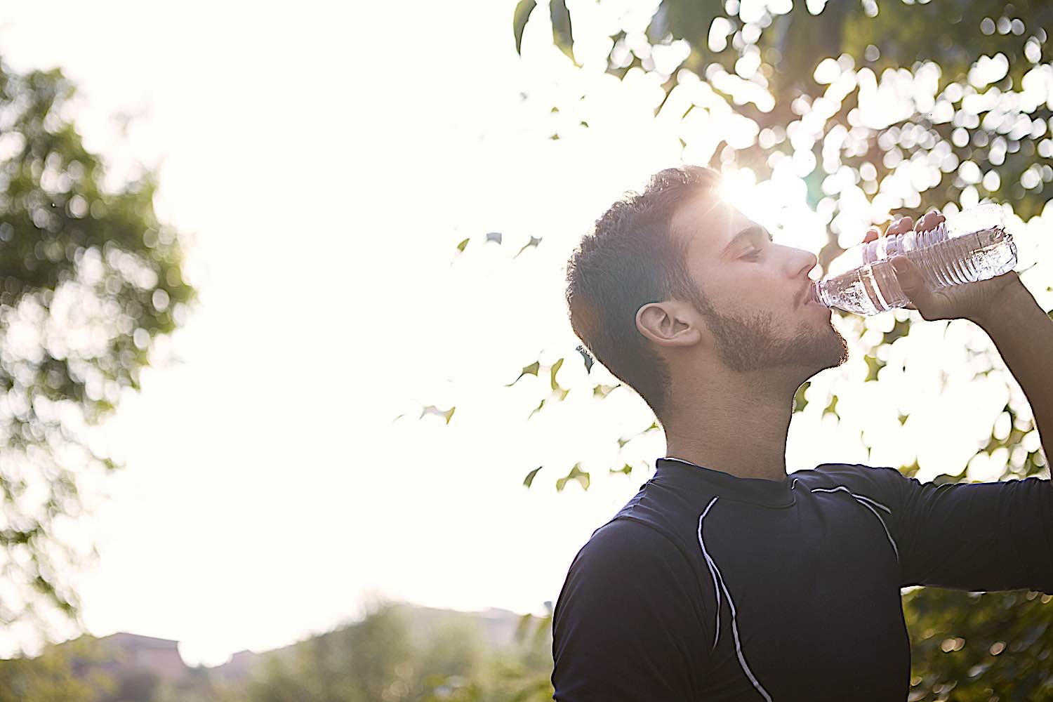 Buddha Weekly Man drinking water in nature a chance to be mindful dreamstime l 89657820 Buddhism