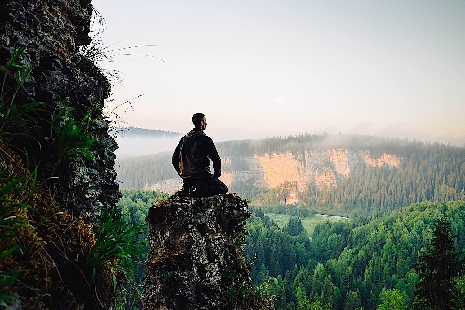 Buddha Weekly Man on top of rock meditation dreamstime l 73662835 Buddhism