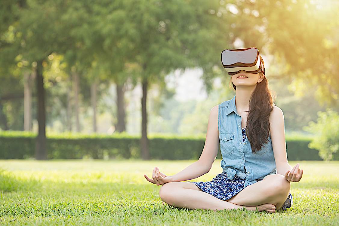 Buddha Weekly Meditating in nature with virtual reality headset Buddhism