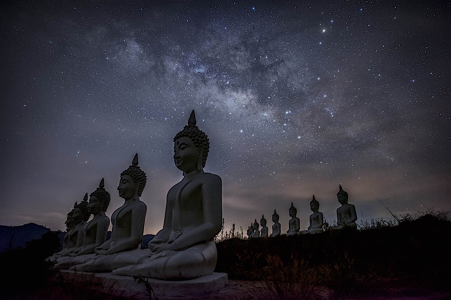 Buddha Weekly Milky way galaxy over buddhas statues at Phu Phra Ban Mak Khaeng Dan Sai Loei Thailand dreamstime l 216853162 Buddhism