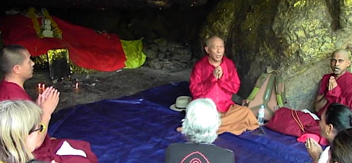 Buddha Weekly Zasep Rinpoche leading practice on Heart Sutra near Vulture Peak in sacred cave India praying Buddhism