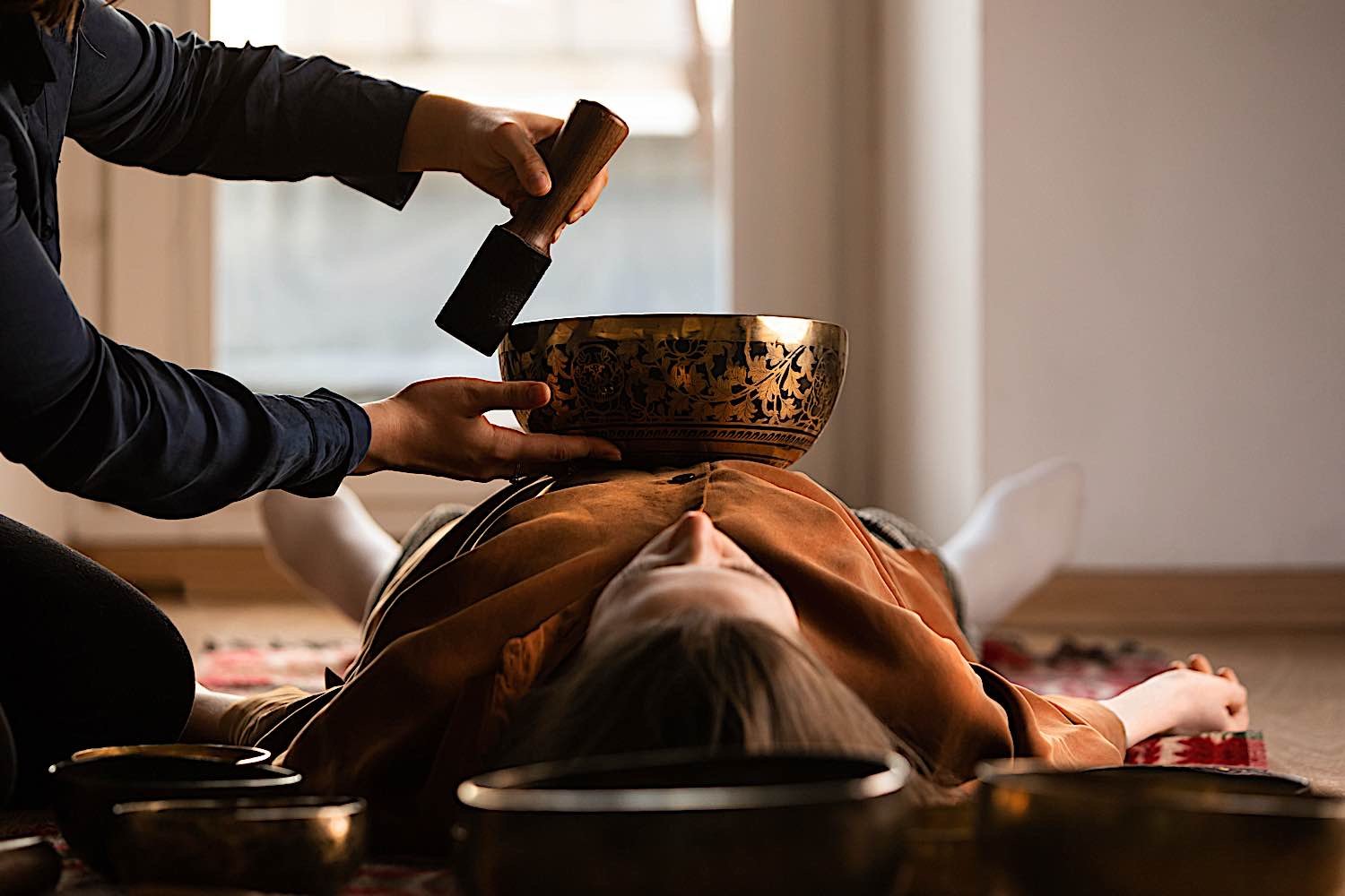 Buddha Weekly woman relaxing with singing bowl played on abdomen dreamstime xxl 184654516 Buddhism