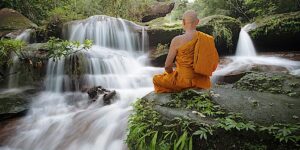 Buddha Weekly Buddhist monk meditating at waterfall dreamstime xxl 155900227 Buddhism custom crop