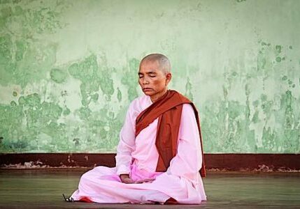 A Buddhist nun meditating during full moon festival at Shwedagon Pagoda. In Buddhism, women are the equal of men in their ability to achieve spiritual attainments.