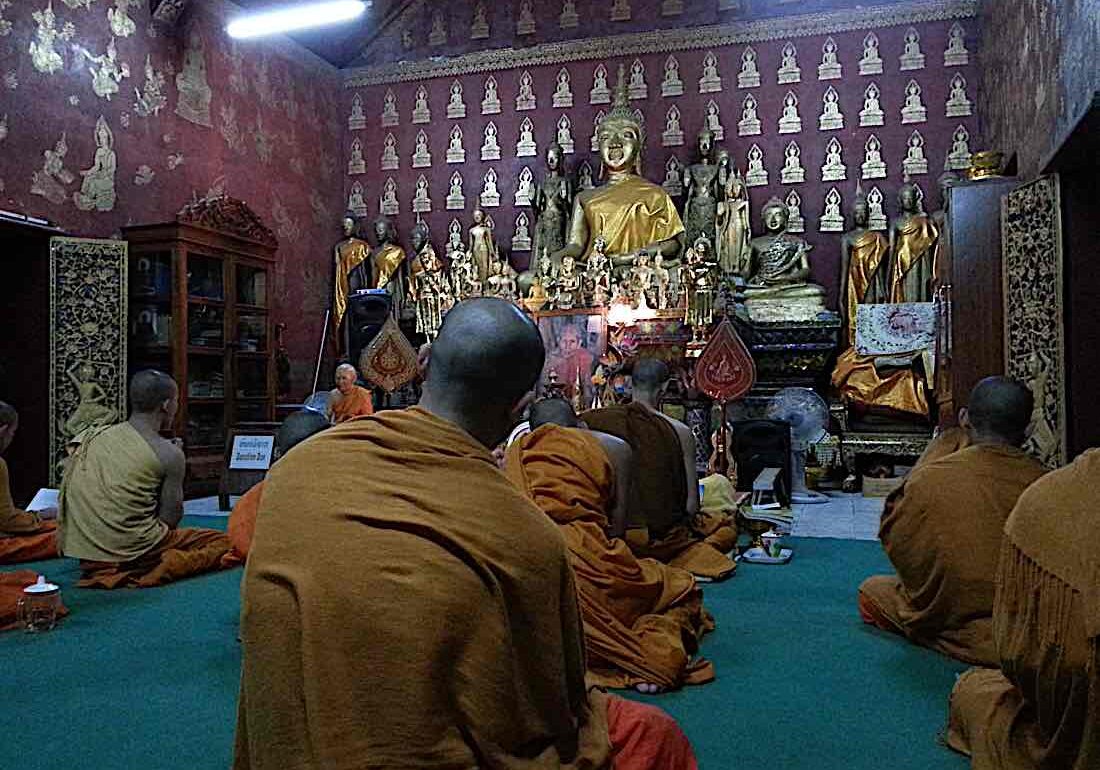 Dao chanting and meditating with monks in Laos.