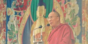 Buddha Weekly Dalai Lama speaking publicaly in front of one of the silk appliqué thangkas Buddhism custom crop