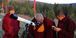 Buddha Weekly Lama Zopa Rinpoche gazes through a telescope FPMT Buddhism custom crop