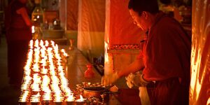 Buddha Weekly Making offerings on Holy Days Monk lighting candles in Drepung Monastery Lhasa Tibet dreamstime xxl 47678157 Buddhism custom crop
