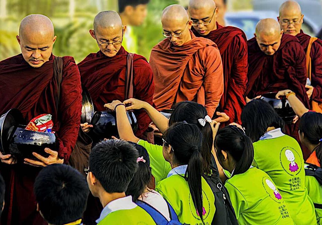 Youth give "dana" to monastic Sangha, a meritorious action.