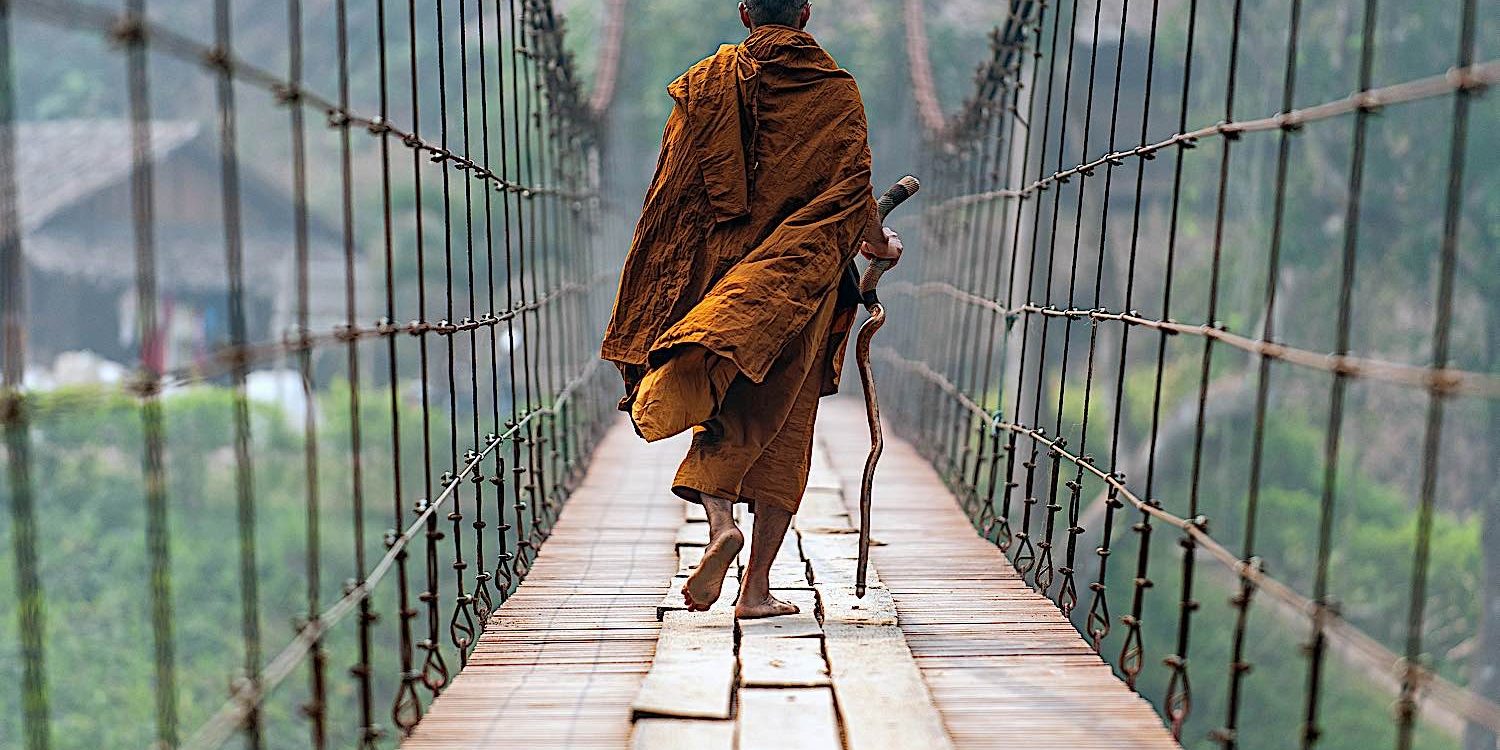 A Theravadan monk crossing a suspension bridge in mae Hong Son.