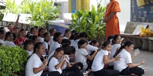 A monk teaching school children at Wat Temple Saraburi Thailand.