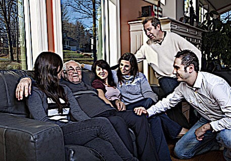 Family looking after elder parent at home. Family looking after elder parent at home. Filial responsibility is taken seriously among most Buddhists.